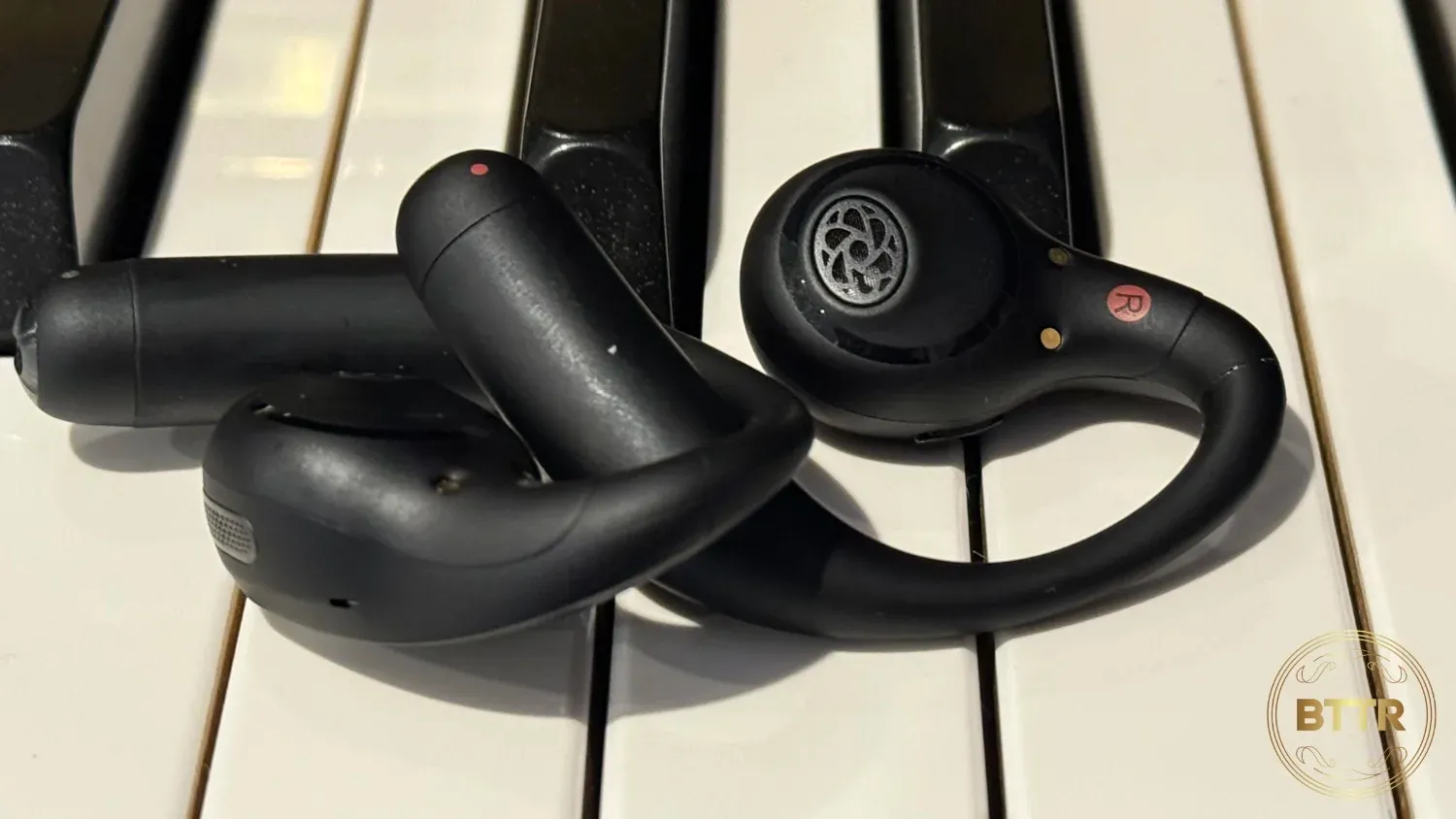 Close up of the earbuds on piano keys