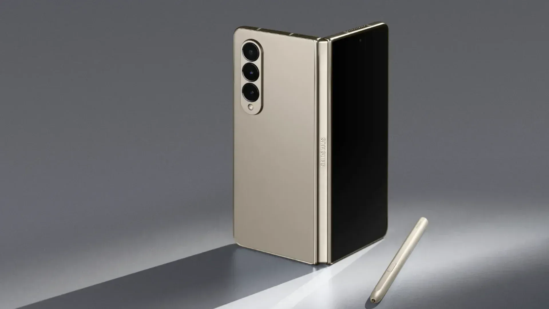 A Galaxy Fold smartphone on a grey background casting a shadow