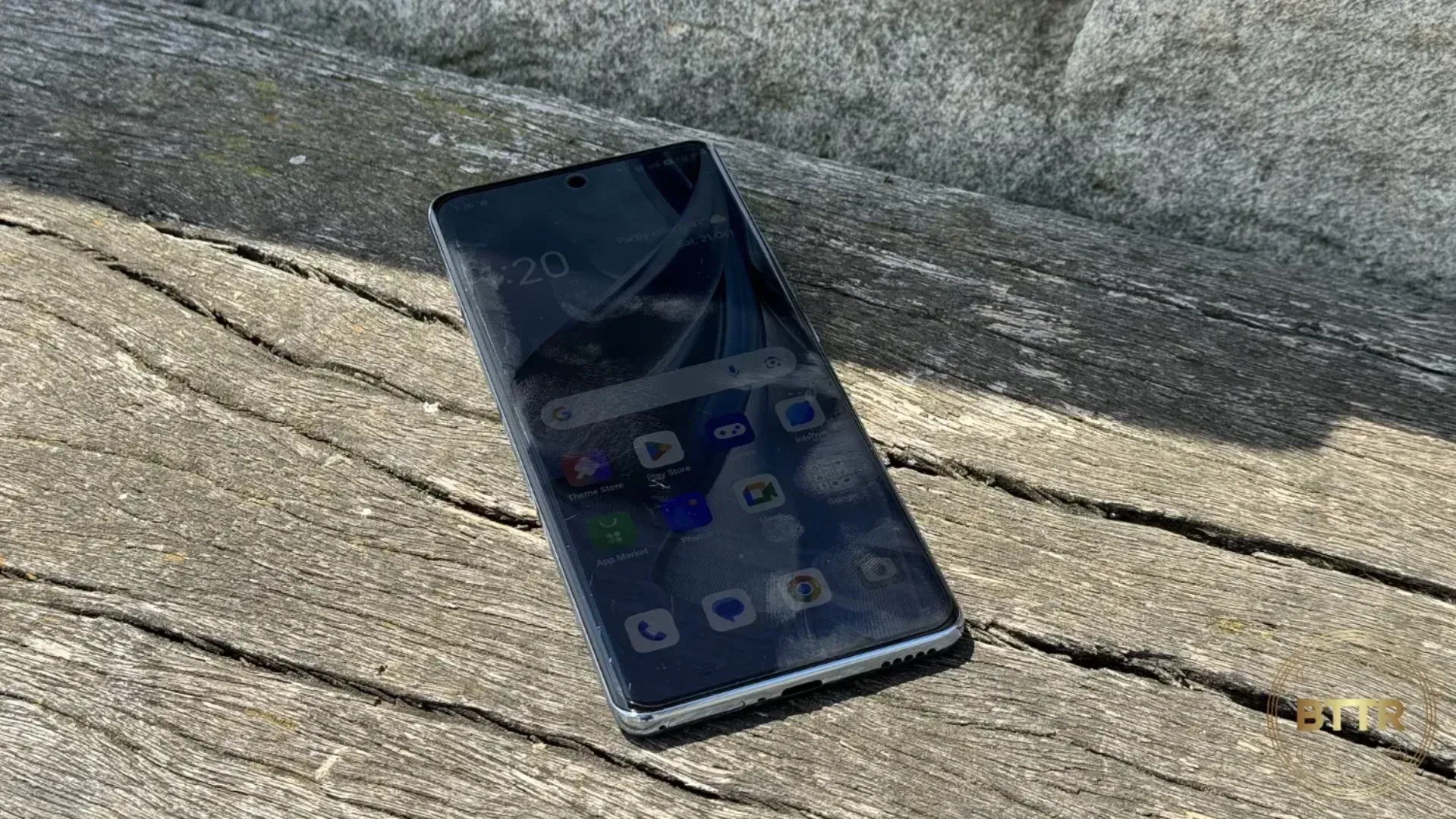 the Oppo Reno 10 5G on a bench