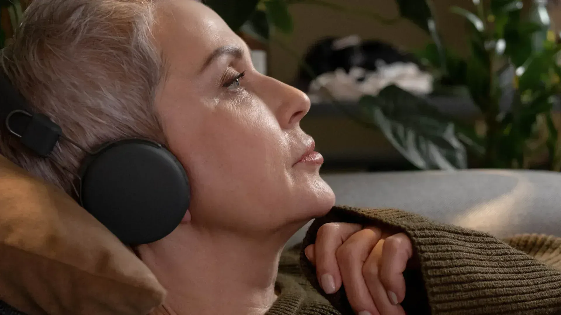 Older lady wearing a pair of wireless bluetooth headphones