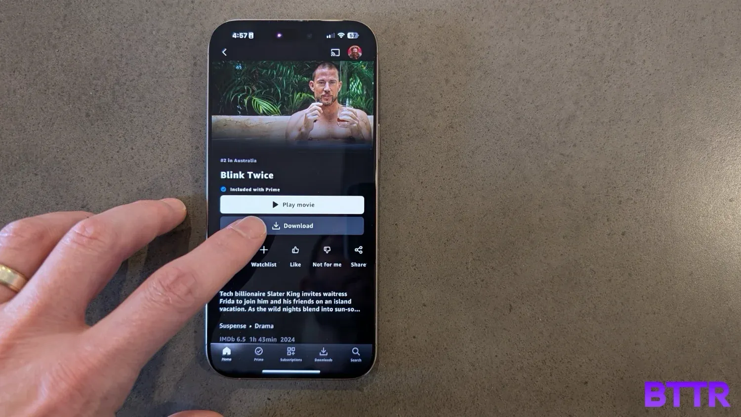A hand pressing the download button in Prime Video app
