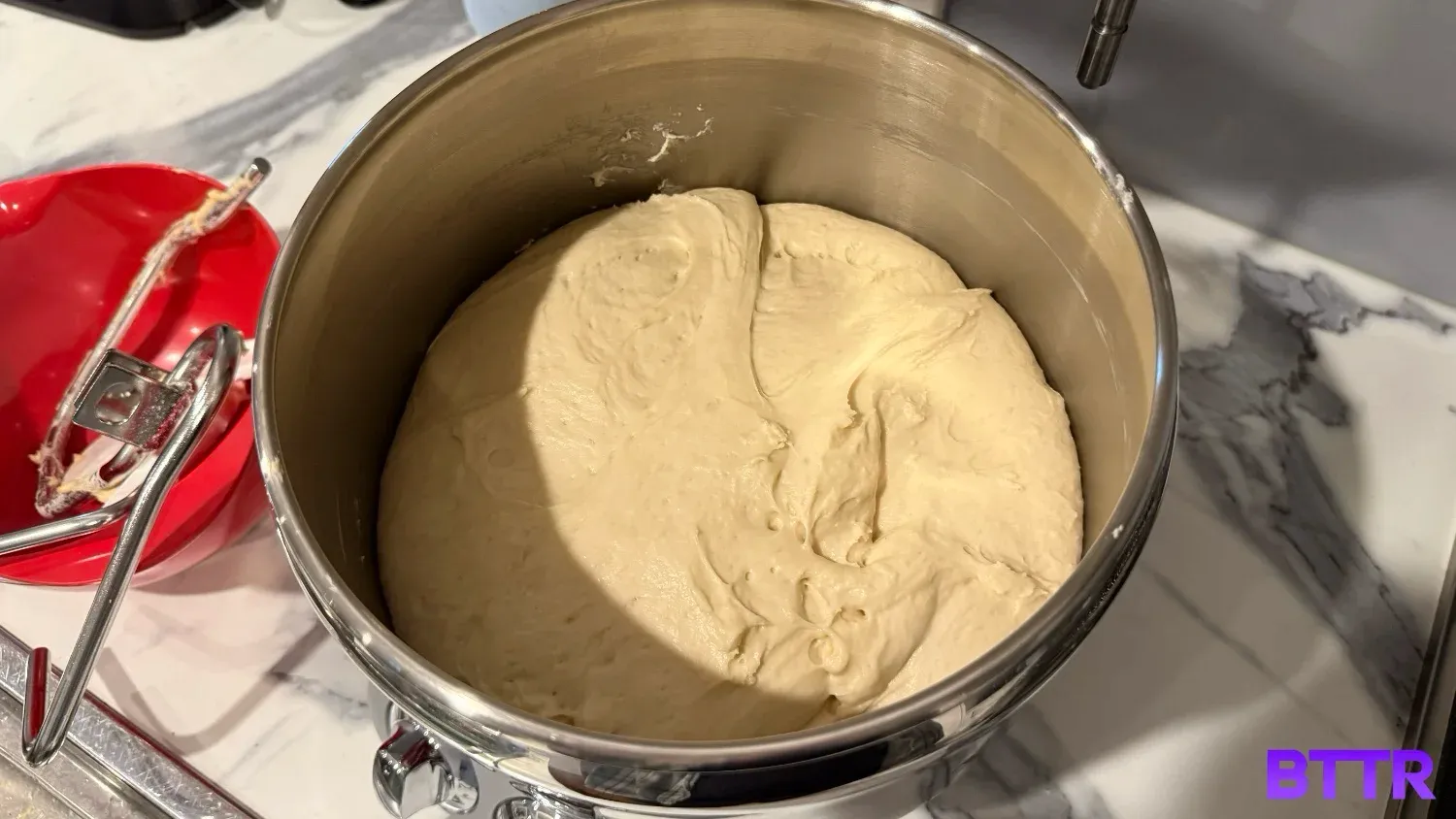 Dough resting in the stainless steel mixing bowl.