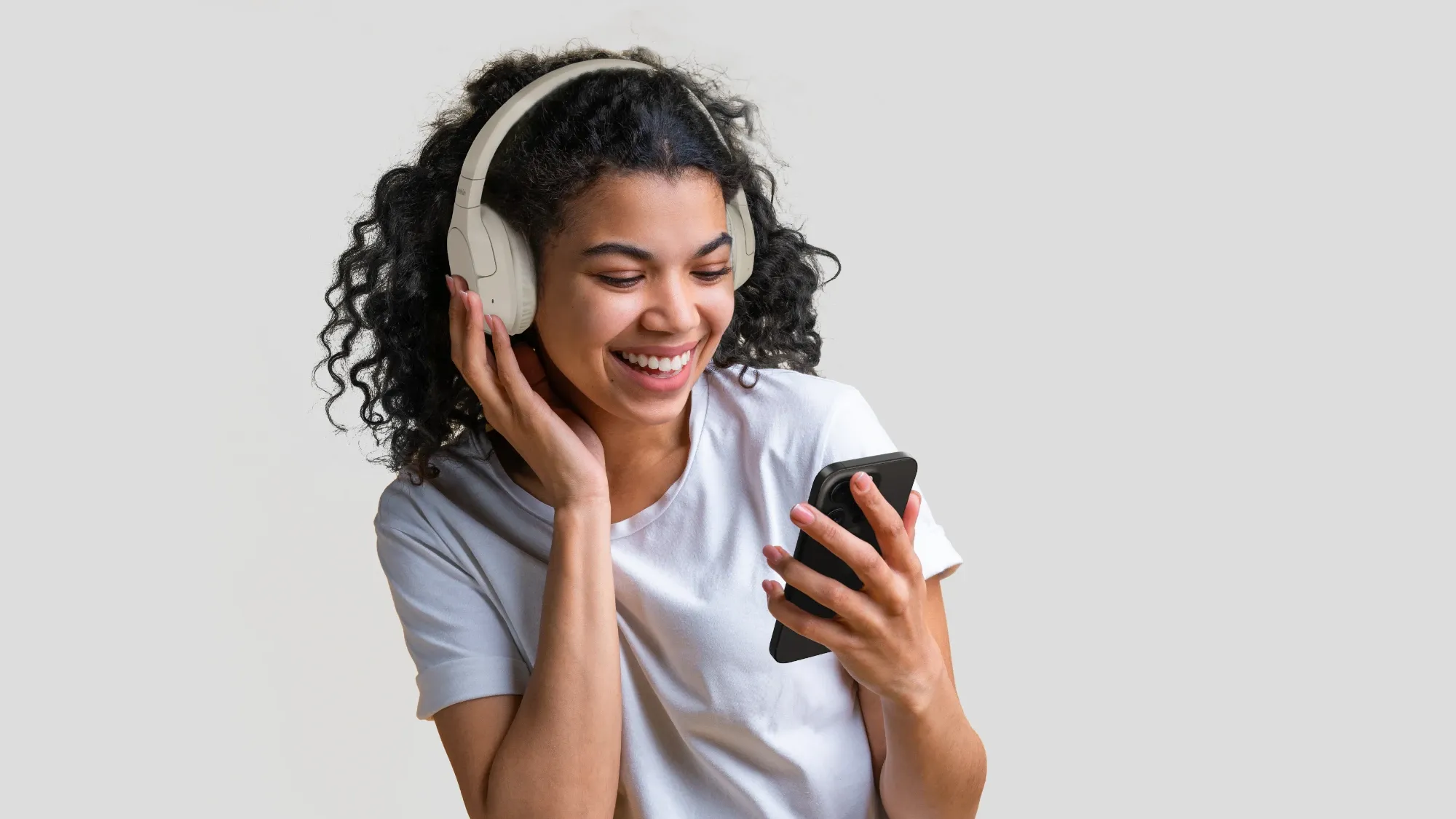 A woman very happy to be wearing the SoundForm Surround headphones from Belkin