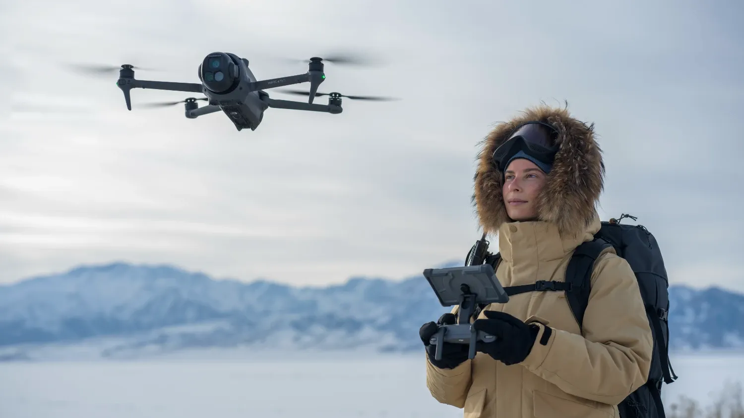 a woman flying the mavic 4 pro in the snow