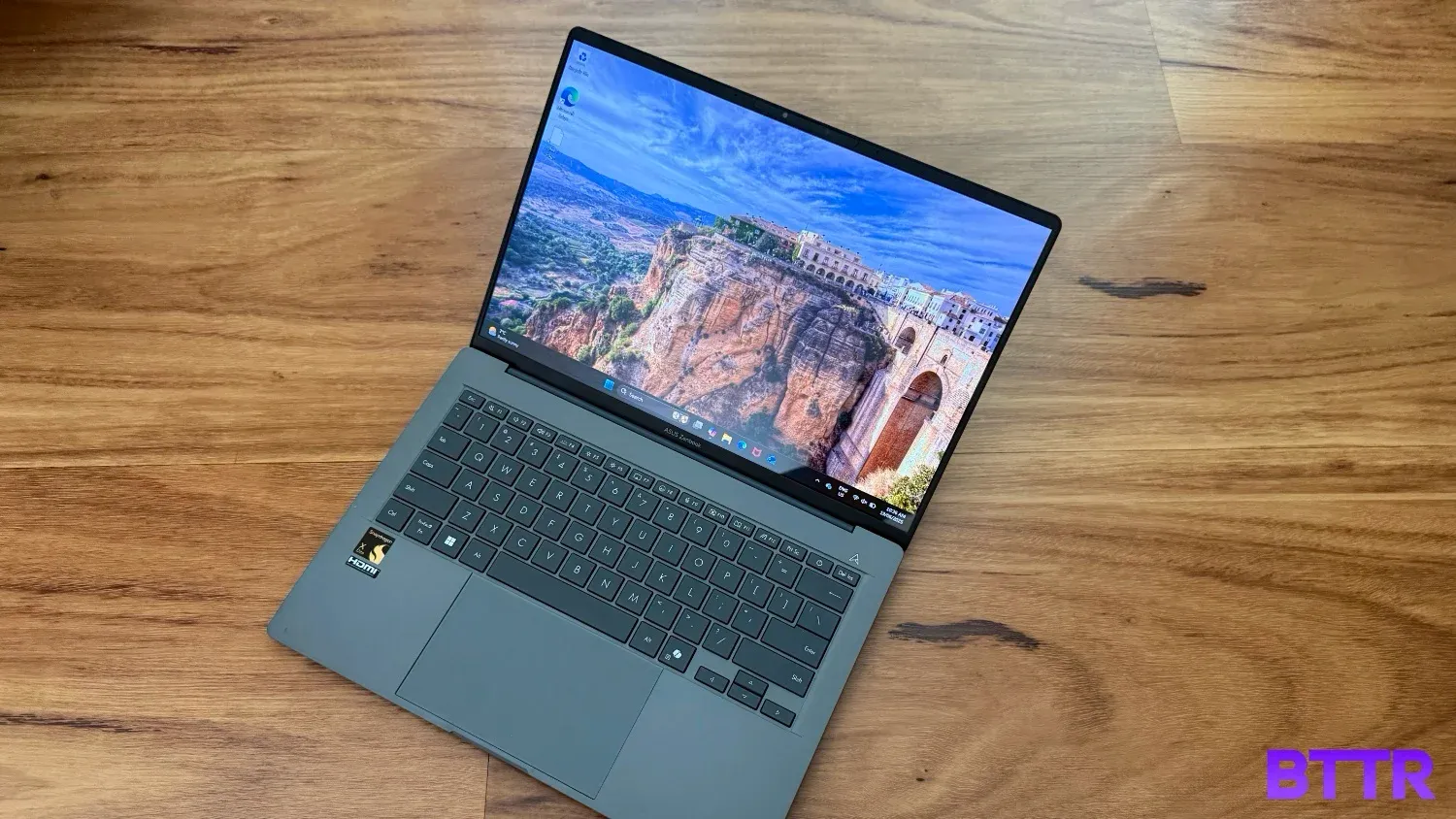 The open Asus Zenbook A14 on the floor