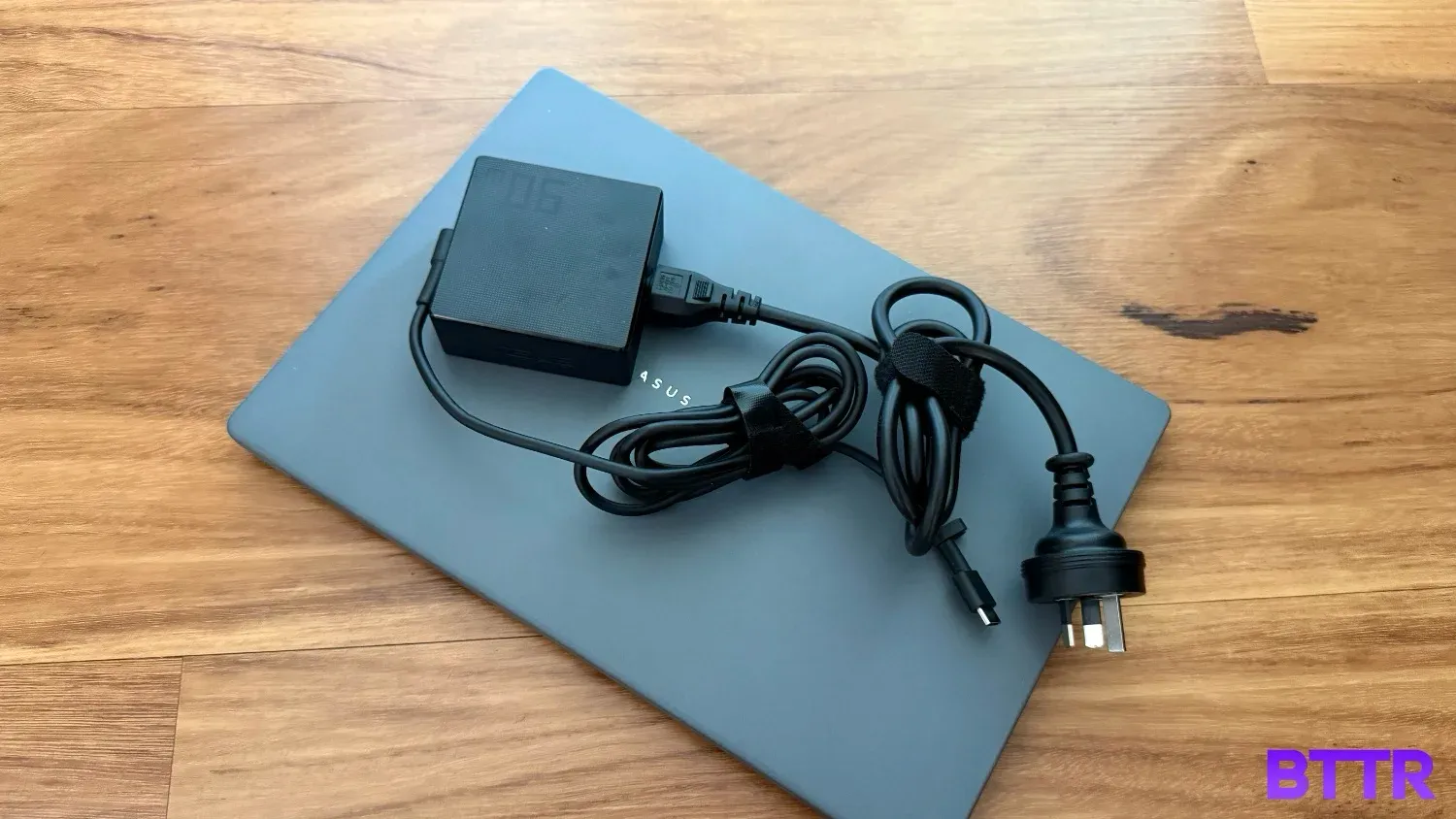 The charger on top of the laptop.