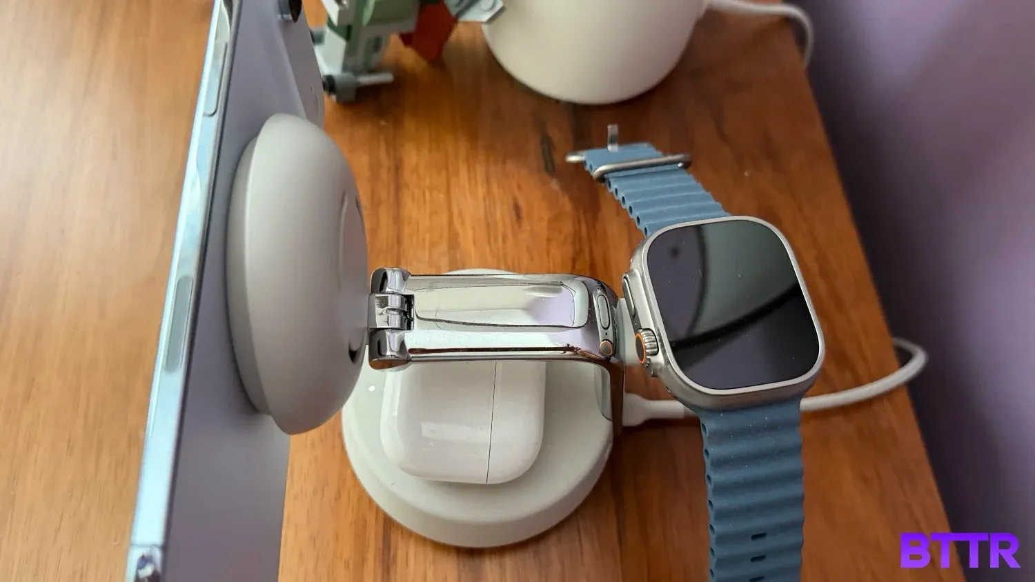 Top down view of he Belkin UltraCharge Pro 3-in-1 25W Qi2 charger charghing an iPhone Air, AirPods Pro and Apple Watch Ultra