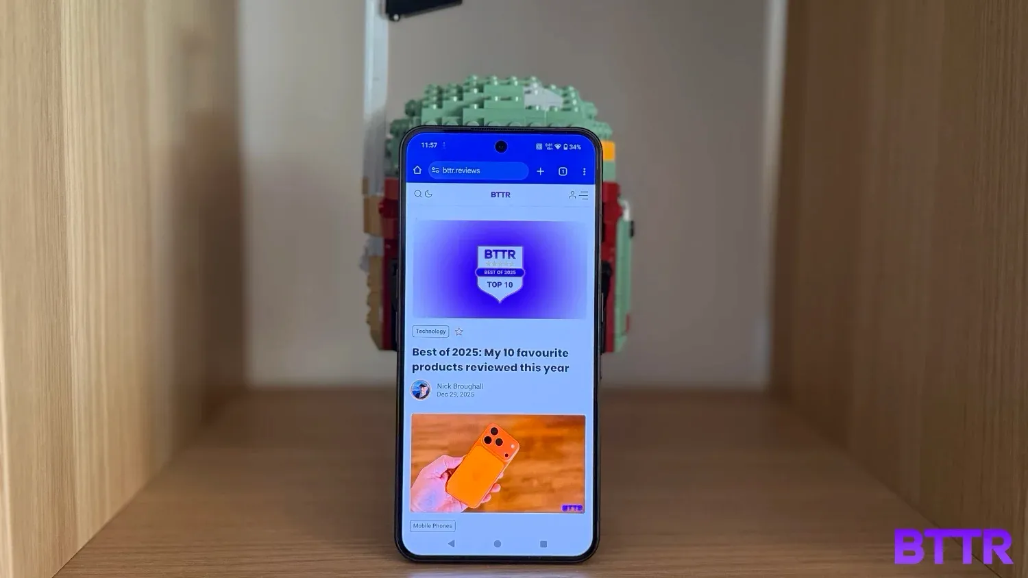 Browsing BTTR.reviews on the Nothing Phone (3) as it rests in front of a Lego Boba Fett helmet