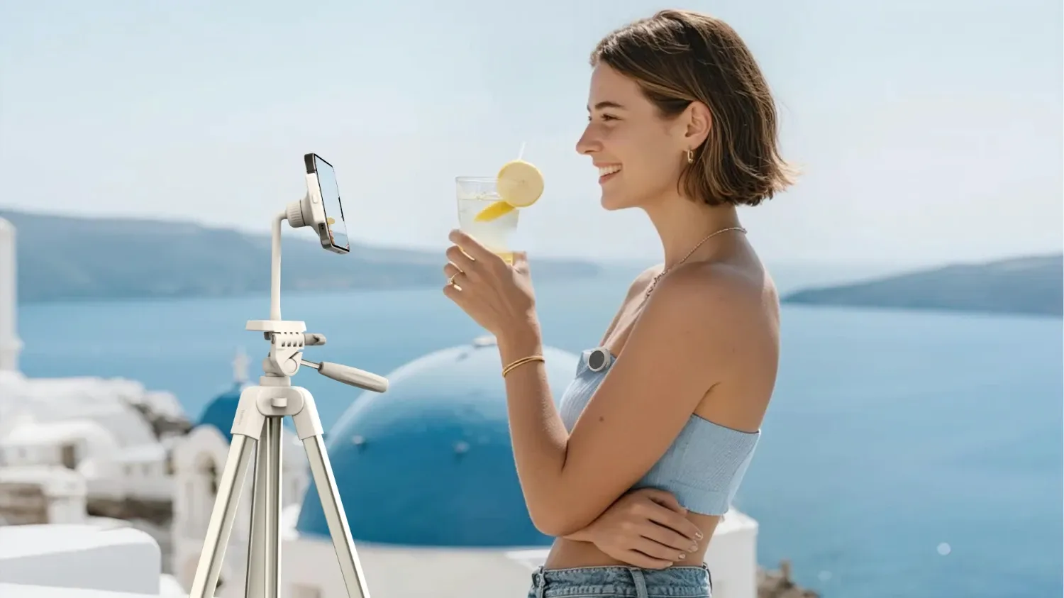 A woman filming a piece to camera using a phone and the Belkin Creator Kit