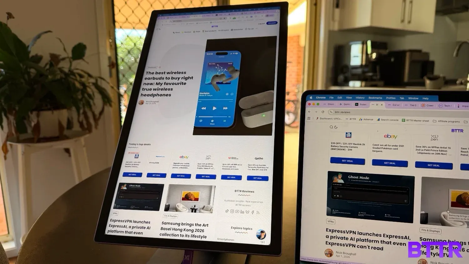The 15 Lite in portrait mode, next to a laptop on a kitchen table