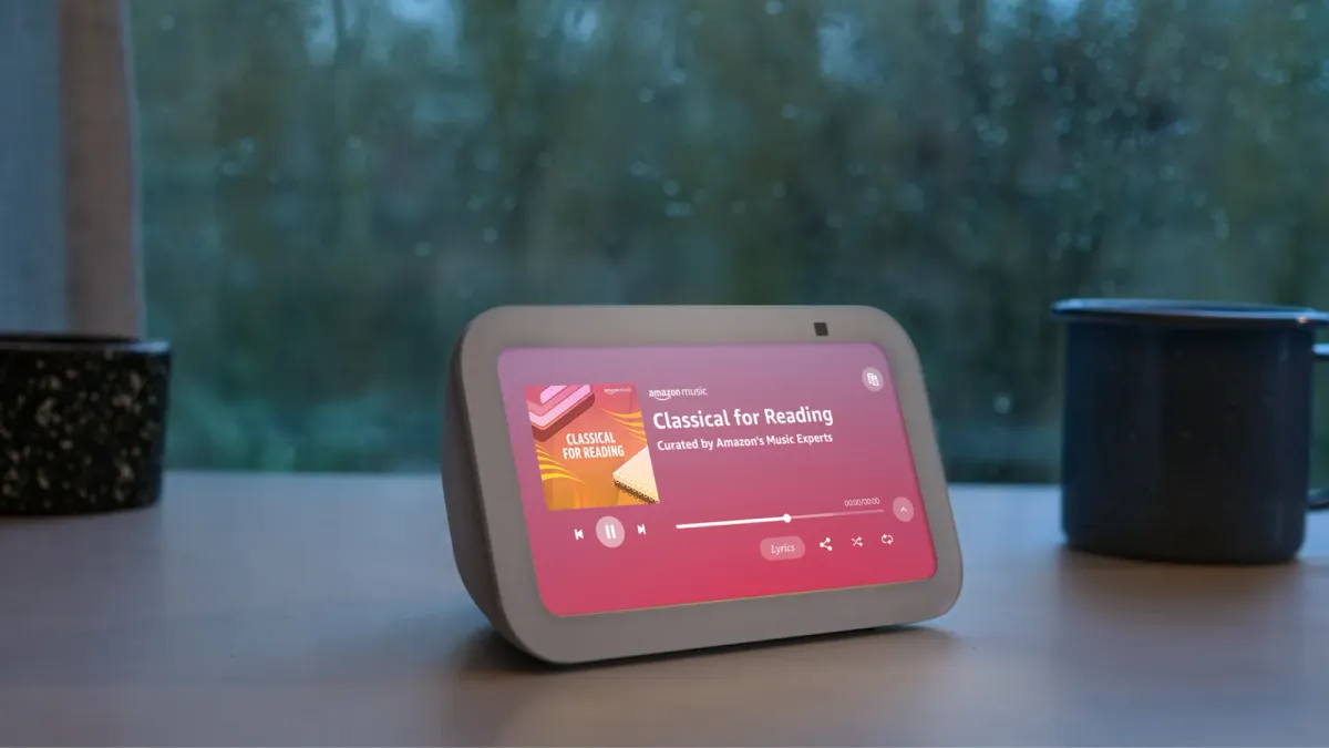 The Amazon Echo Show 5 on a desk playing music