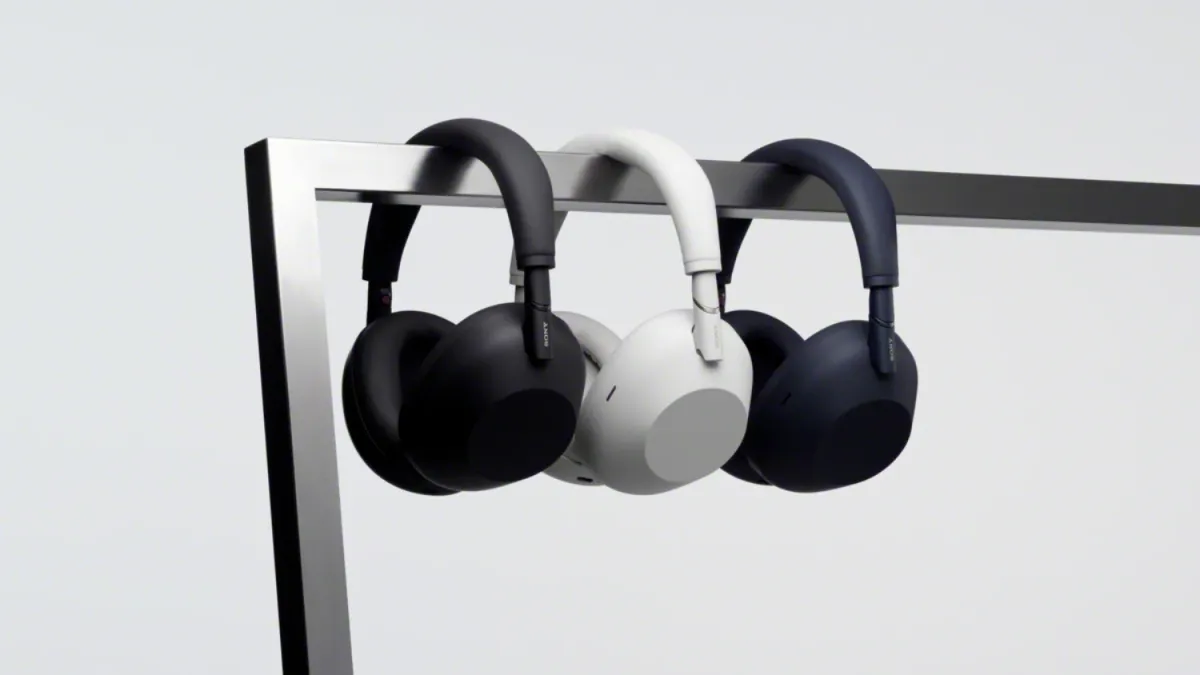 the three colours of the Sony WH-1000XM6 hanging on a metal bar