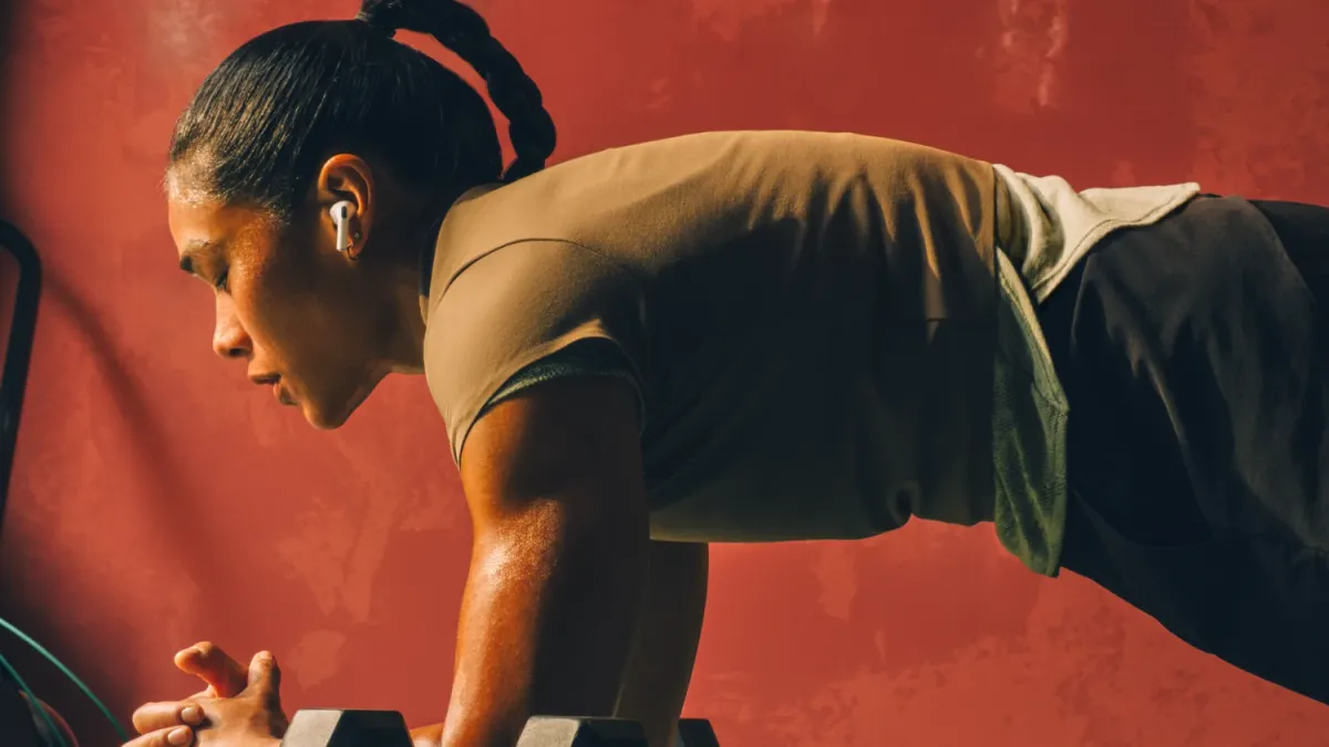 A woman working out with the airpods pro 3