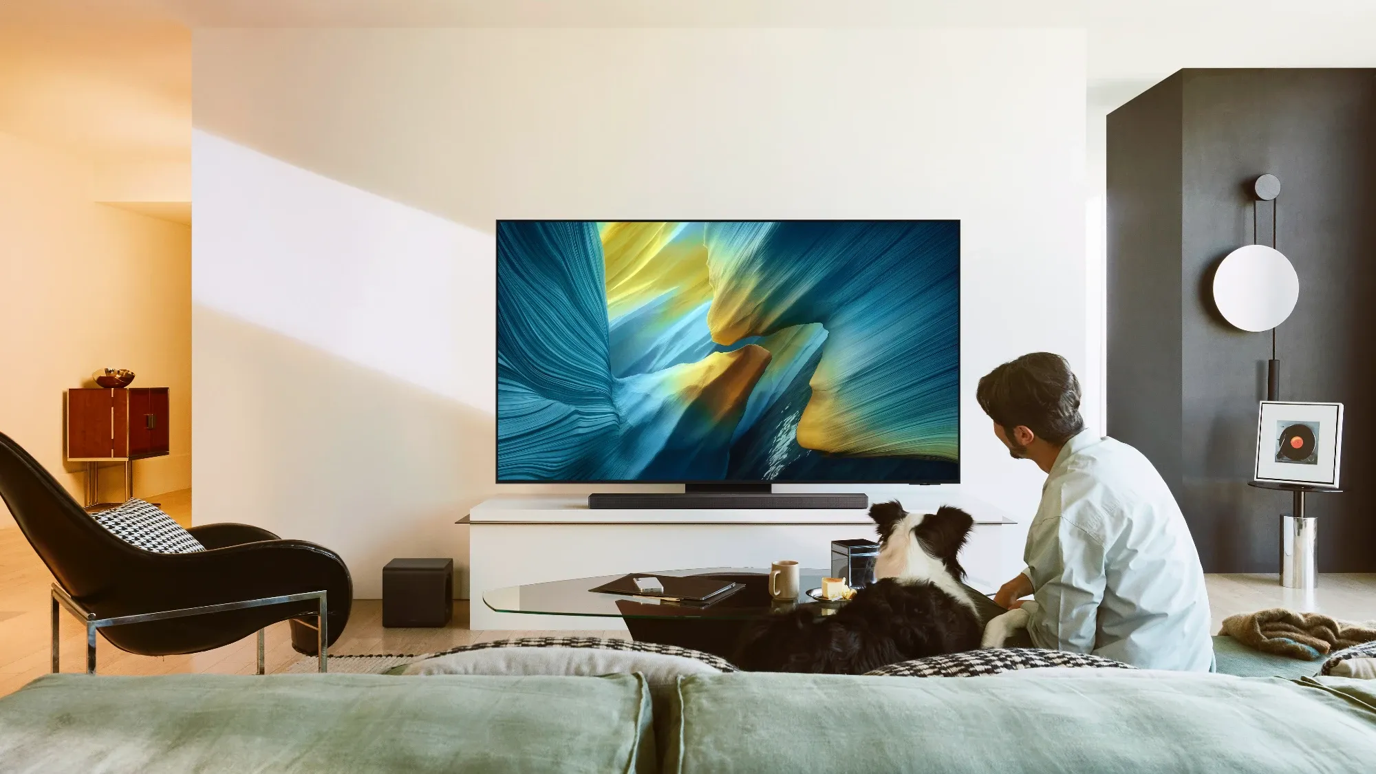 A man and his dog watching the new Samsung OLED TV
