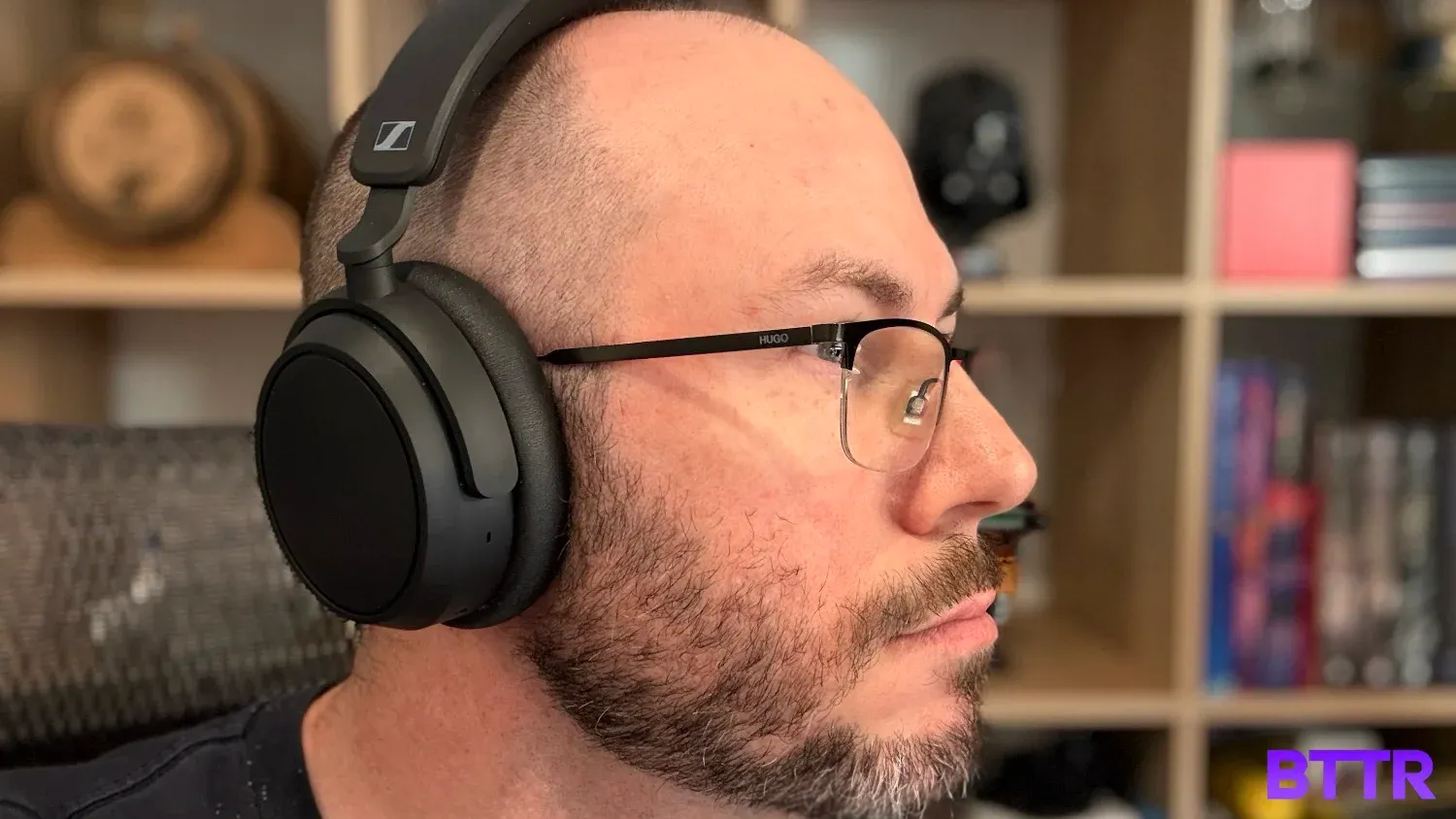 Me wearing the Sennheiser ACCENTUM Plus in front of a bookshelf