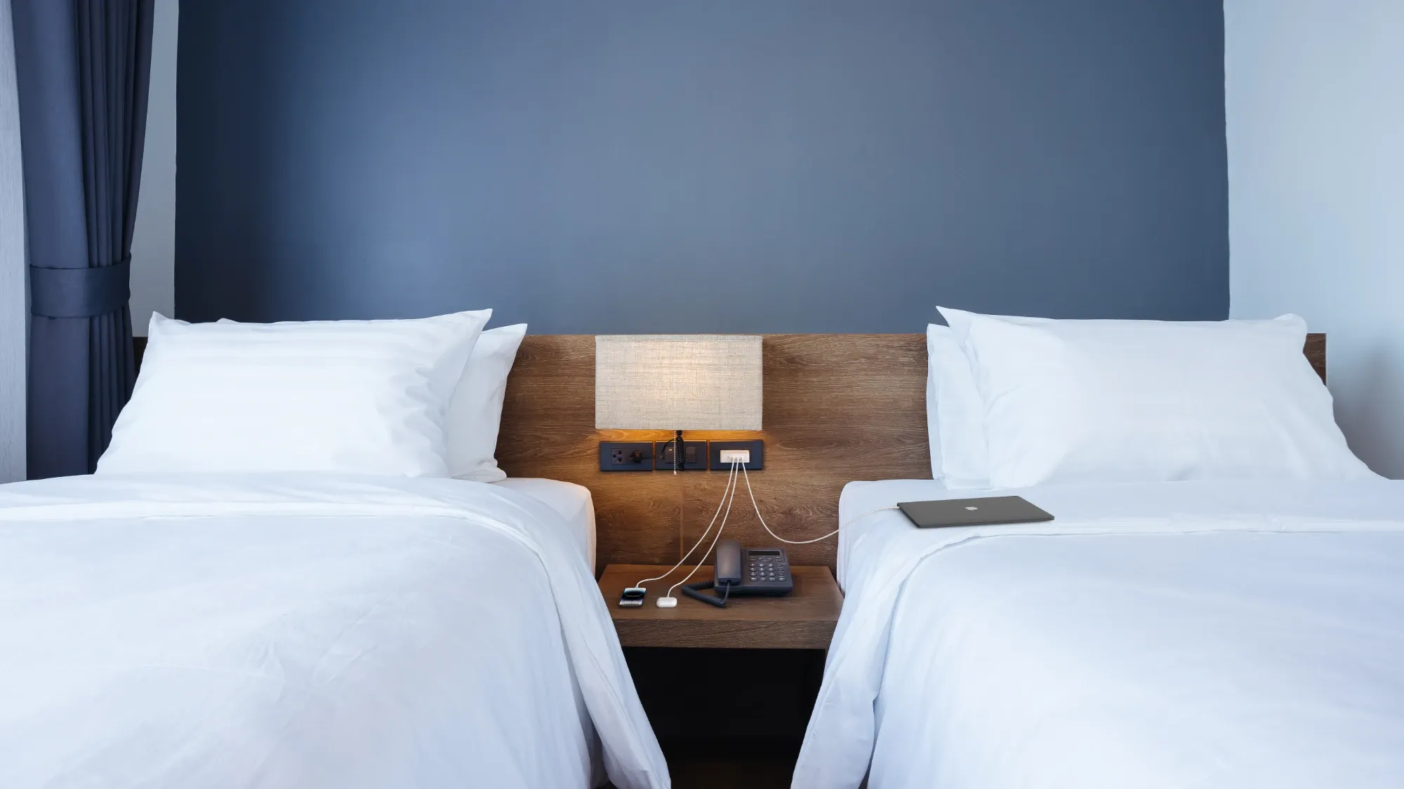 A Belkin charger, made from PCR plastics charging devices in a hotel room.