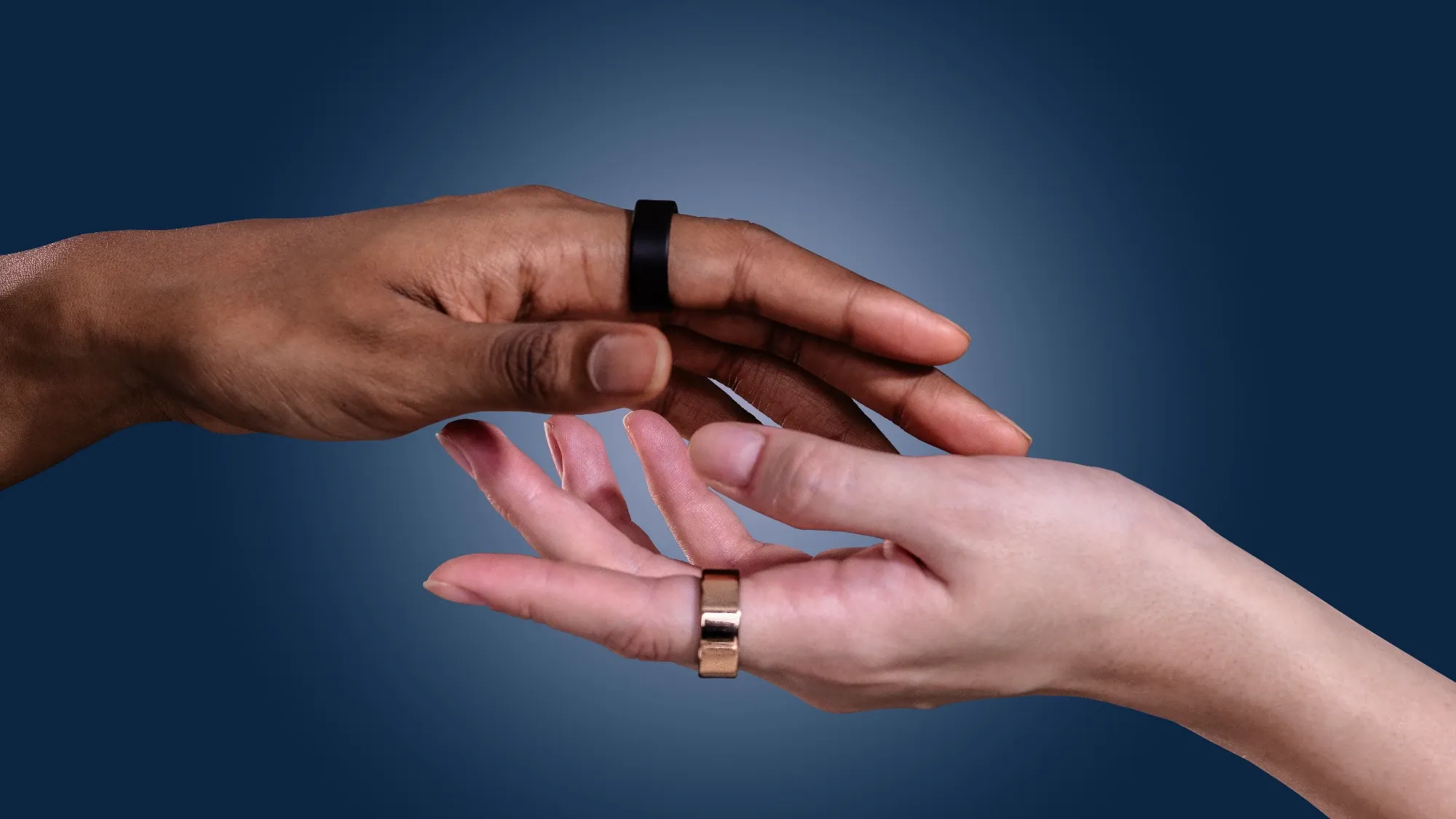 Two hands wearing the Ultrahuman Ring AIR in different colours