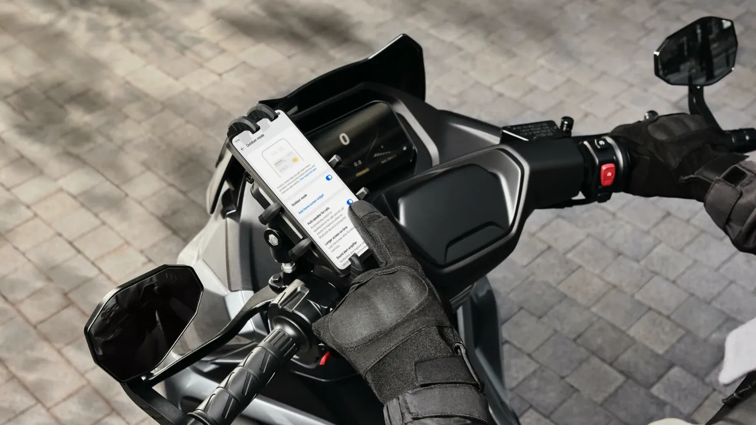 The OPPO A5 Pro 5G on a motorbike being controlled with thick gloves