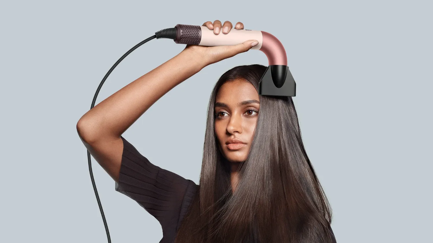 A model using the new Dyson Supersonic r pipe hair dr