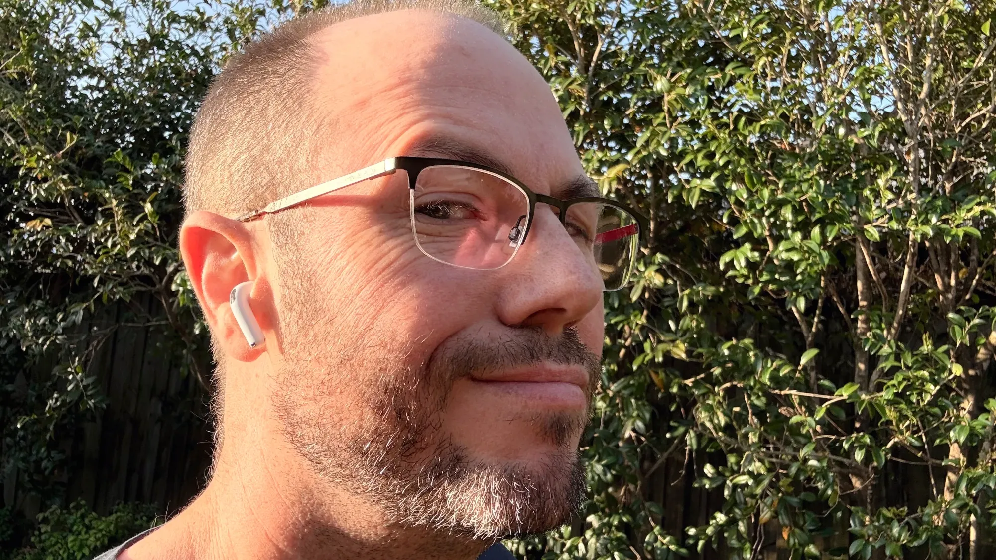Me in the garden wearing a pair of Airpods 4
