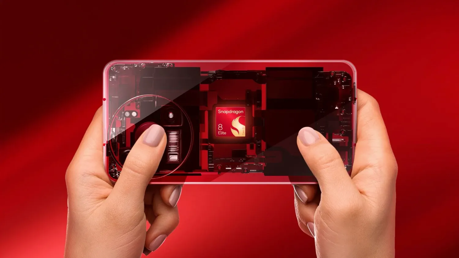 The Snapdragon 8 Elite chip in a transparent hone held by a pair of well manicured hands