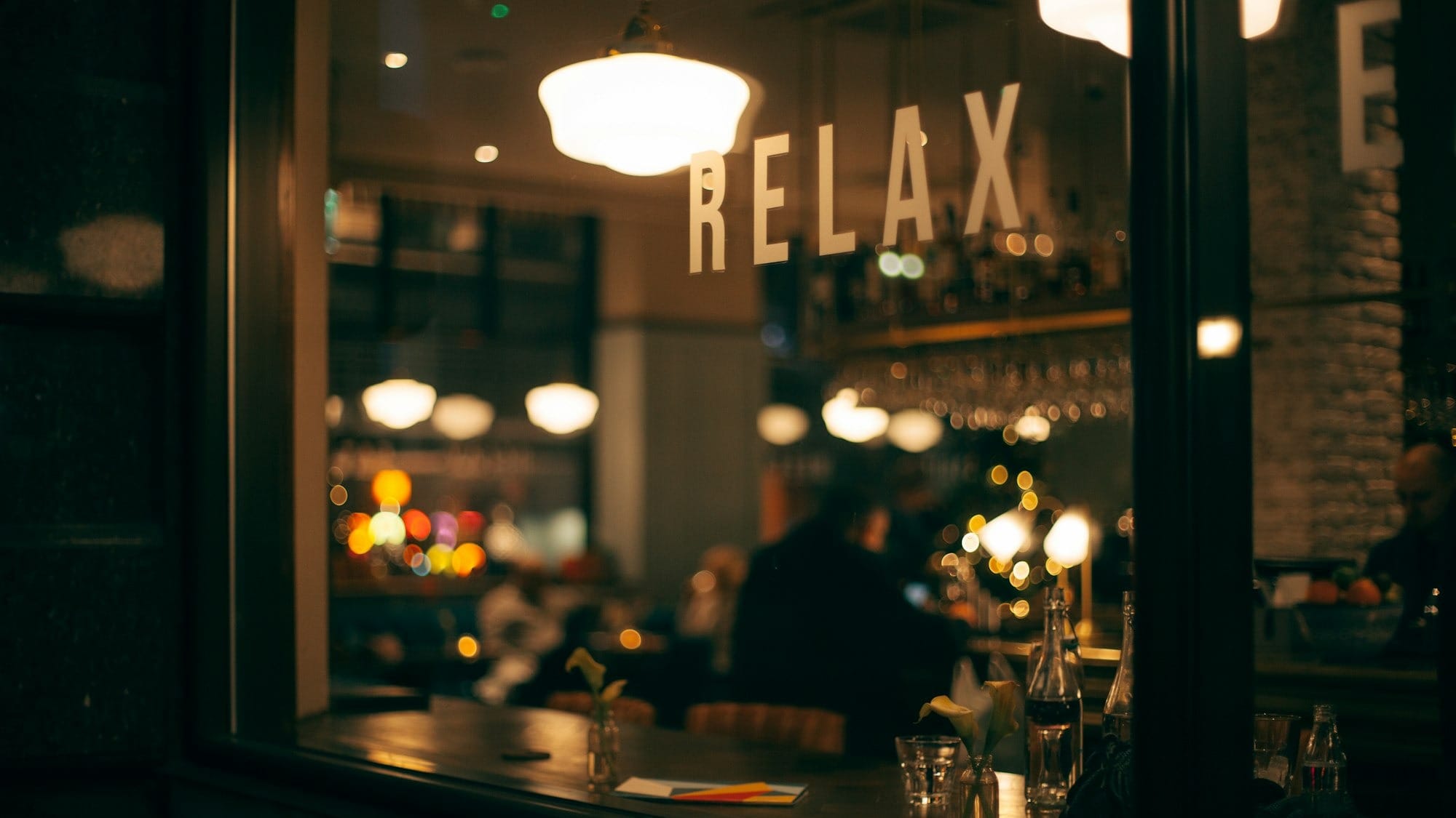A window on a bar saying "relaxx"