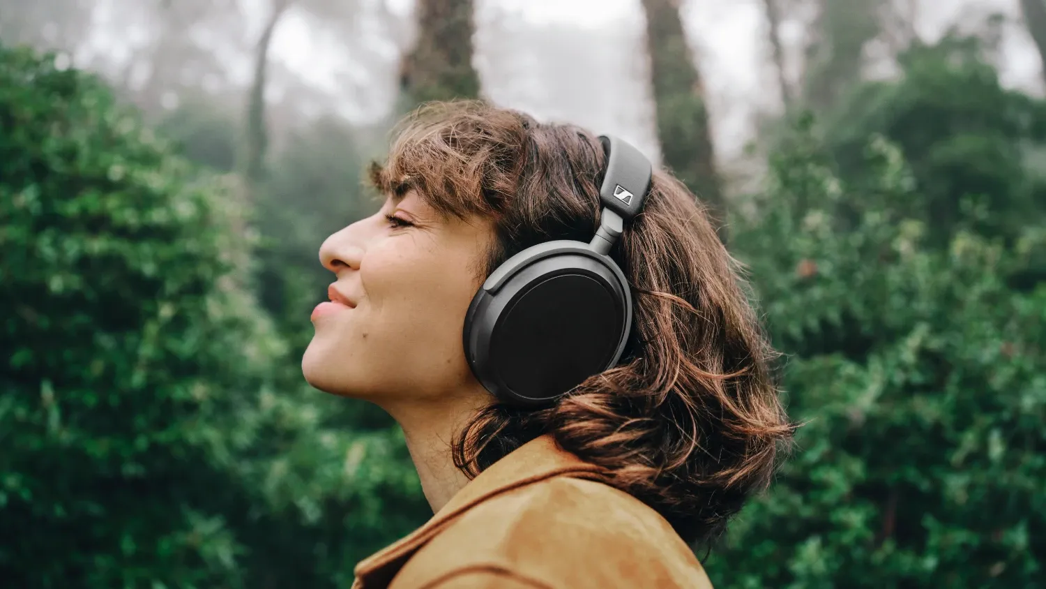 A woman in nature wearing the Sennheiser HDB-630