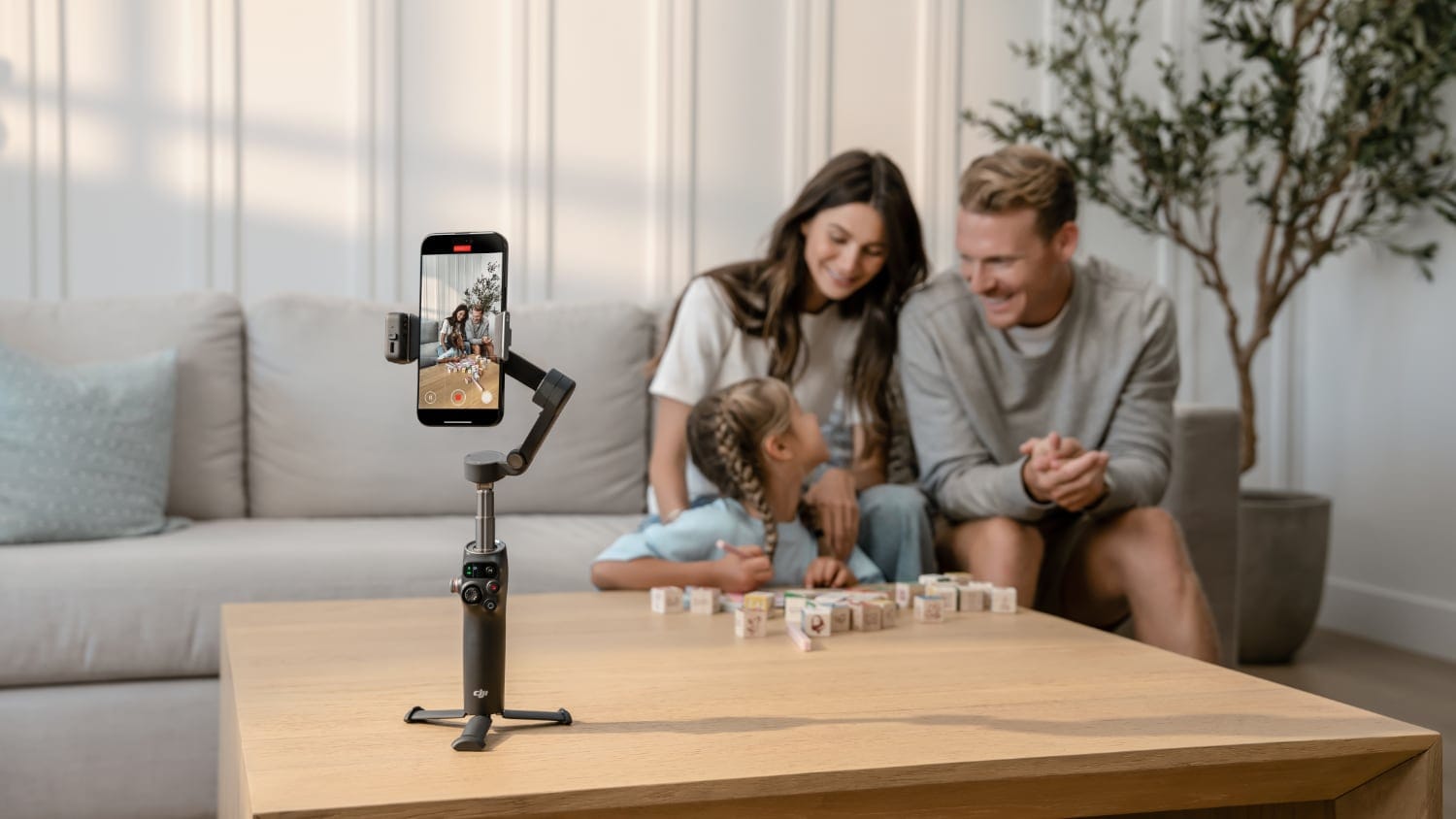 The DJI Osmo Mobile 8 being use dto record a young family.