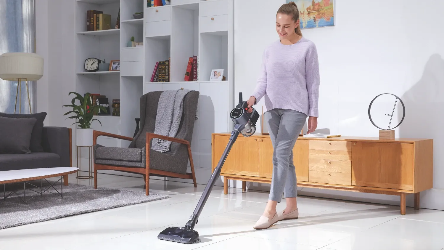 A woman using the LG Cordzero A9L TITAN to vacuum and mop