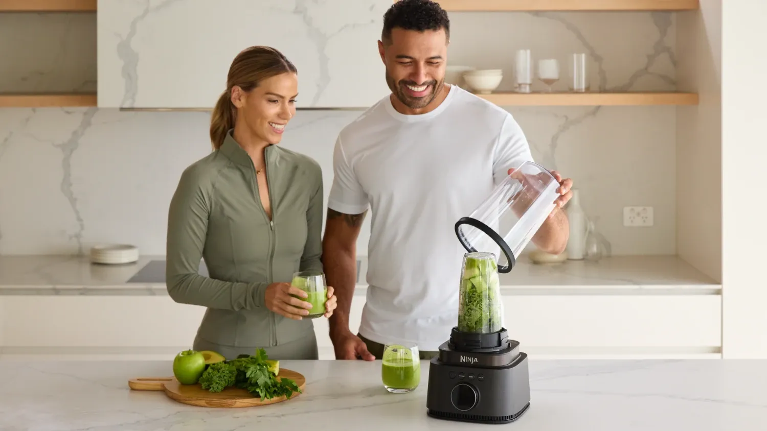 A couple using the Ninja Stealth iQ Blender to make a very green smoothie