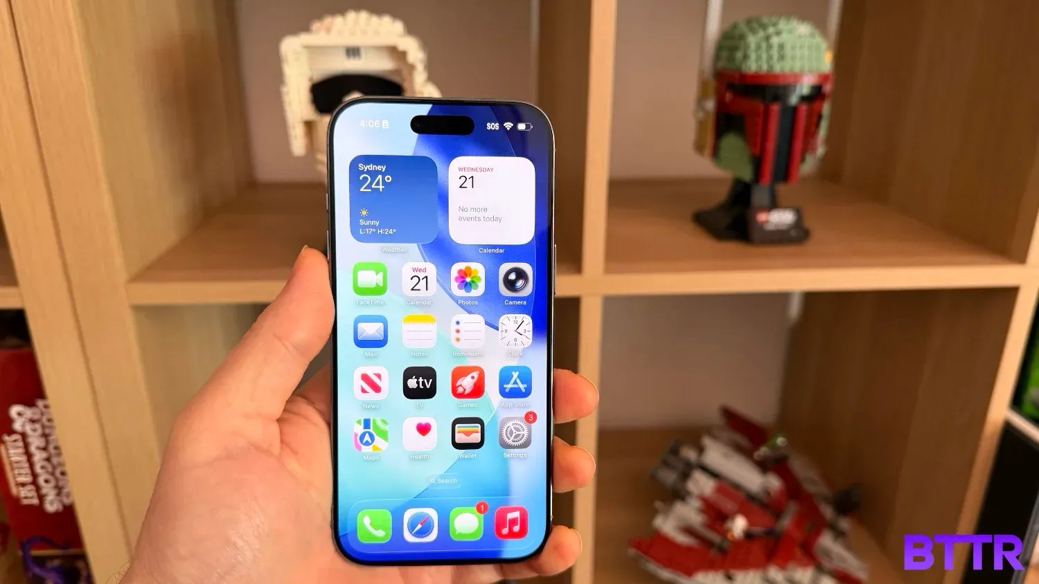 Holding the iPhone Air in front of lego Star Wars helmets