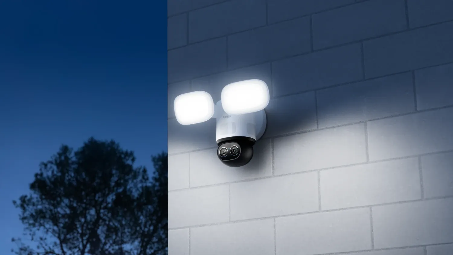 The ReoLink TrackFlex Floodlight WiFi on a wall at night