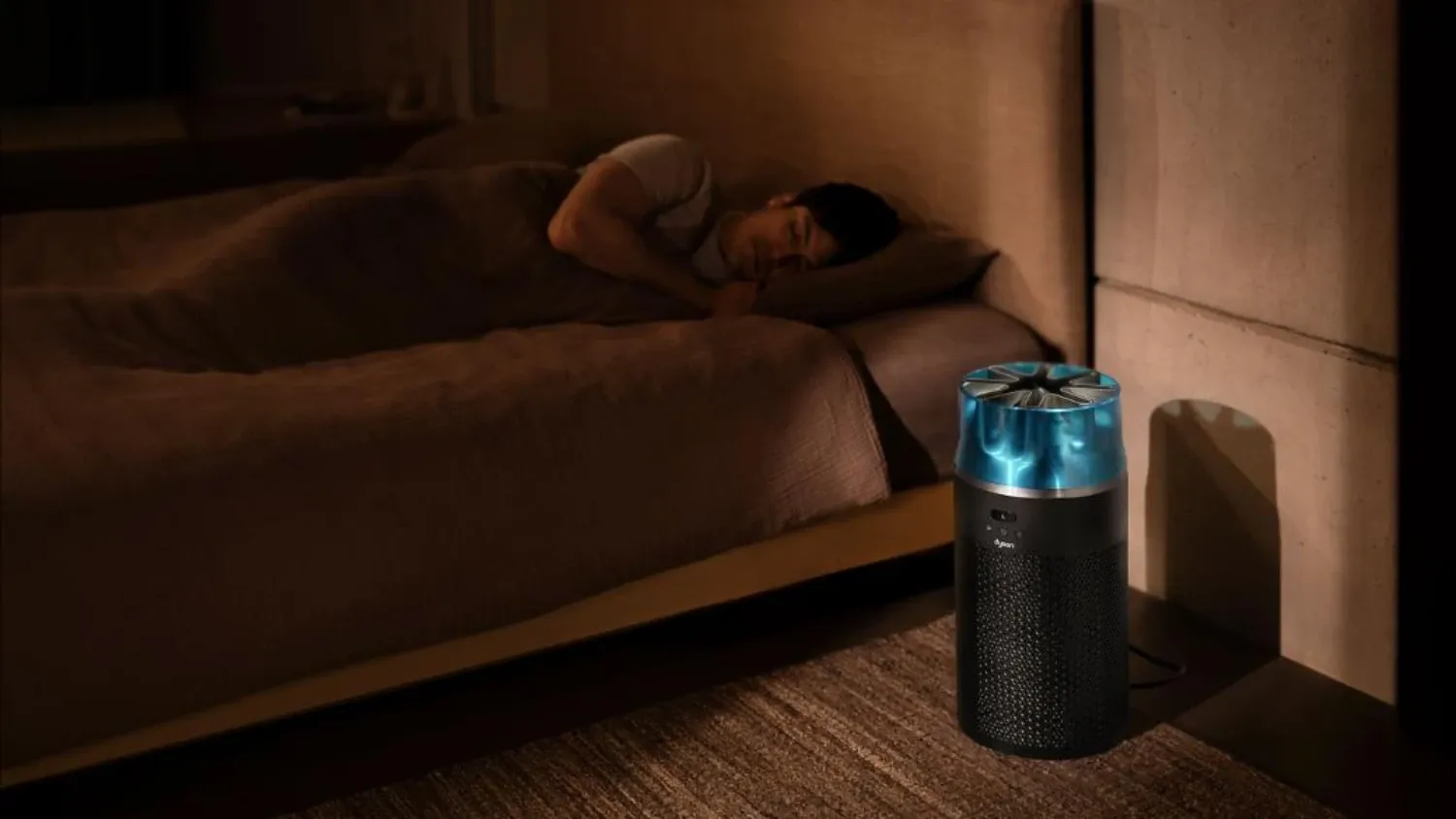 the Dyson hushjet next to someone sleeping in a bed.