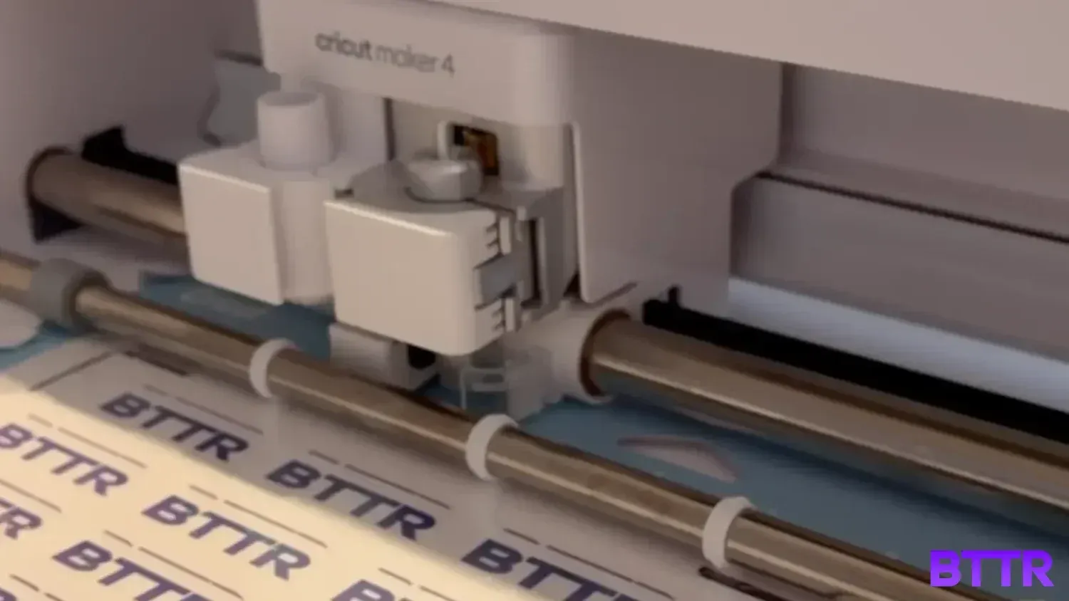 The Cricut Maker 4 cutting out BTTR stickers