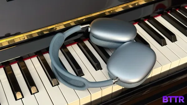 The Blue AirPods max sitting the keys of a piano