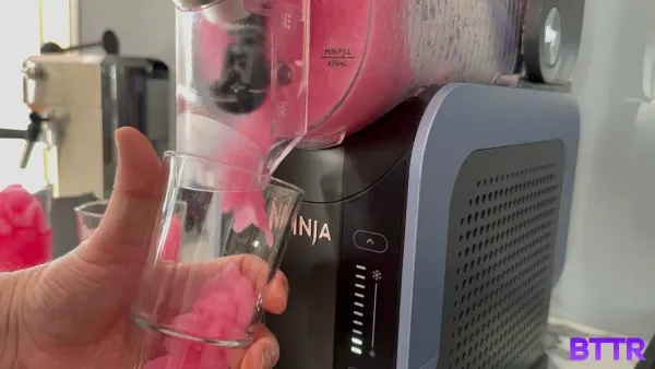 Pouring out ice-cold slush from the Ninja Slushi for the review