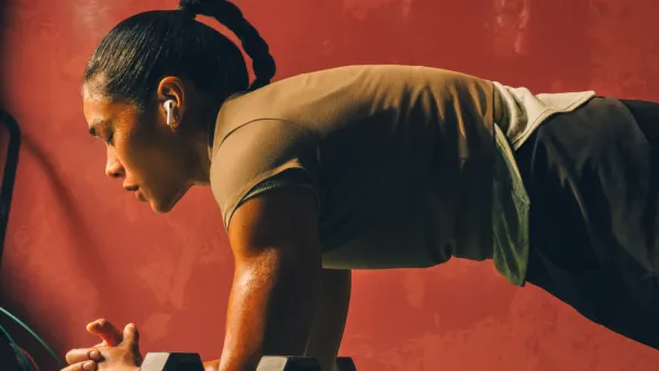 A woman working out with the airpods pro 3