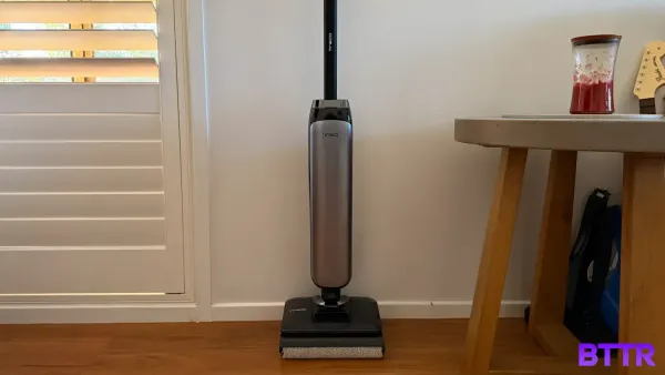 The Tineco Floor One S9 Artist Pro against a wall